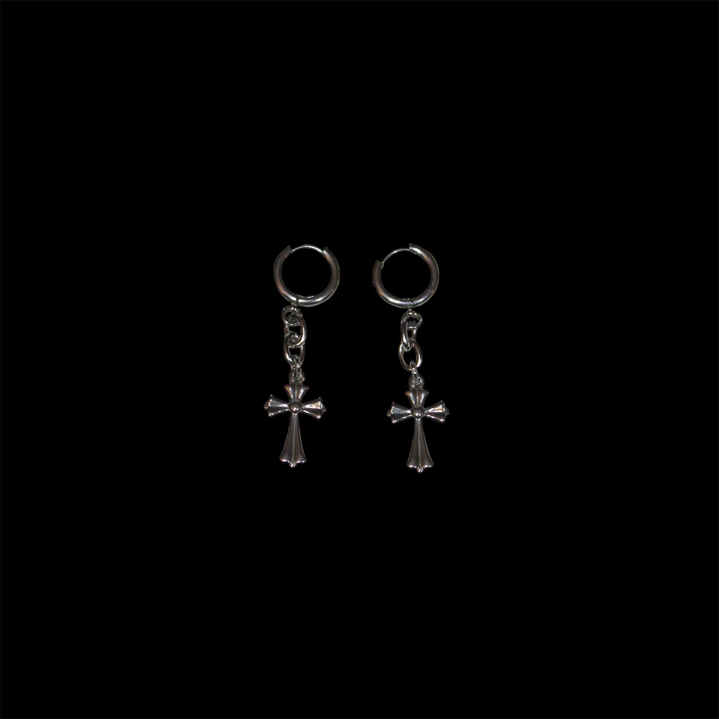 Pair of stainless steel cross drop earrings on a black background