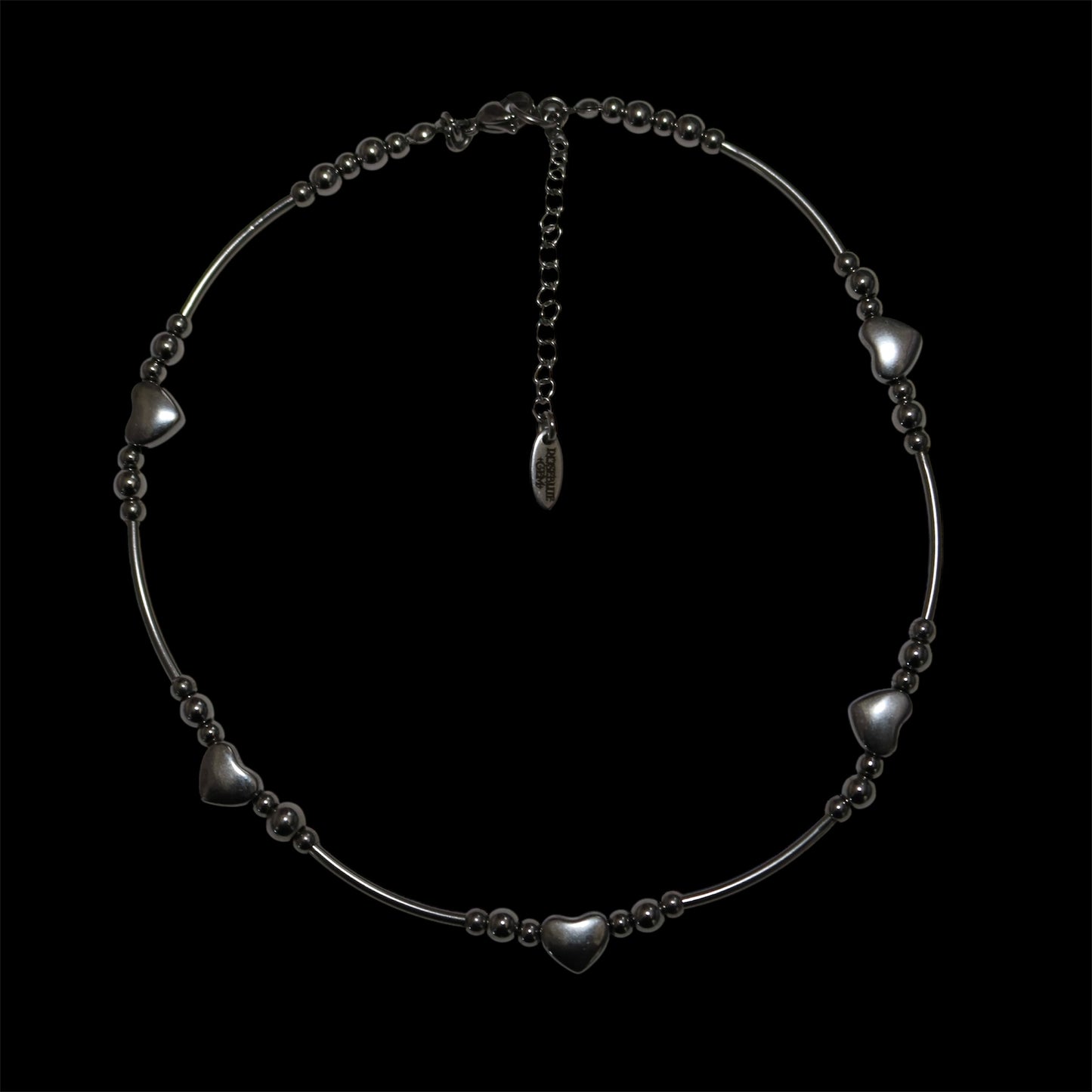 Stainless steel tube bead necklace with heart-shaped beads on a black background