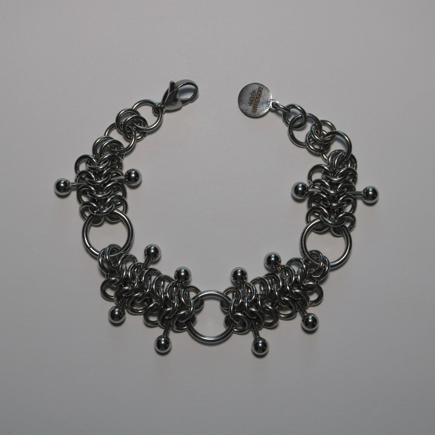 chainmail 4 in 1 bracelet with barbells on a white background