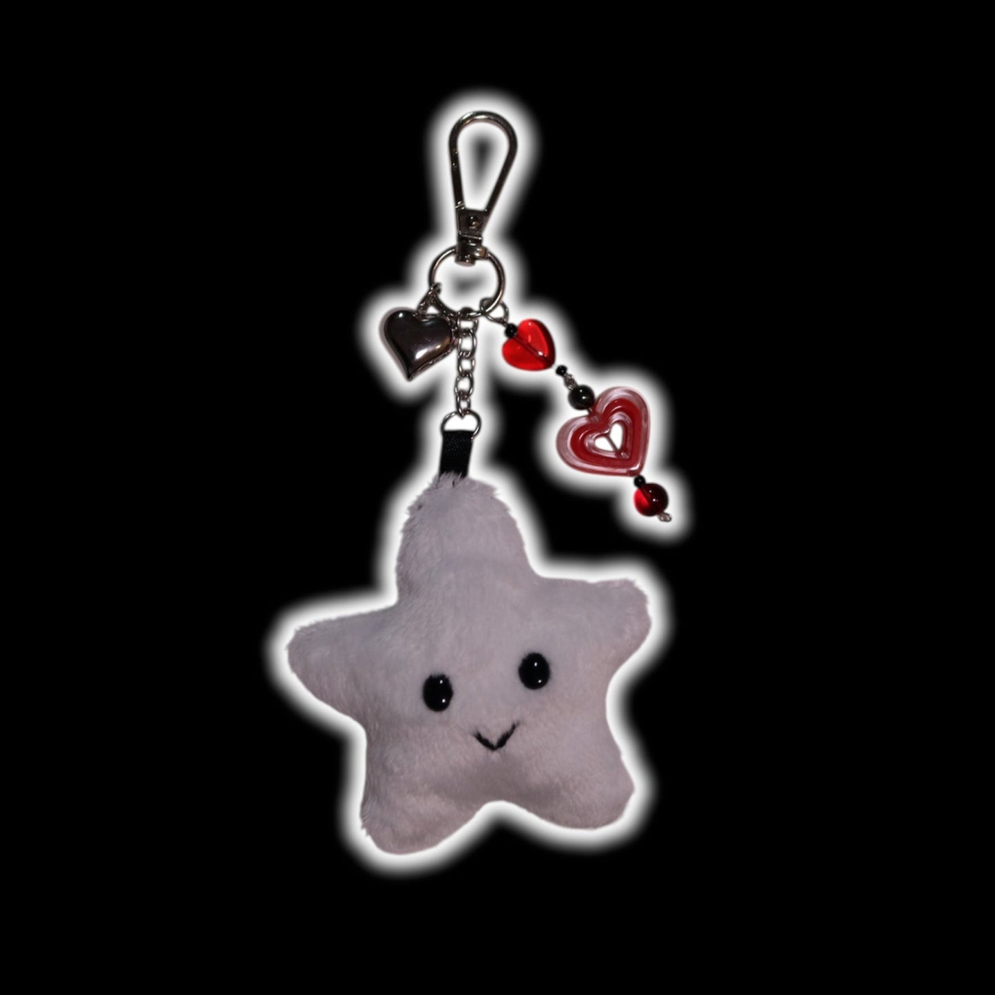 Star-shaped keychain with a smiley face on a black background