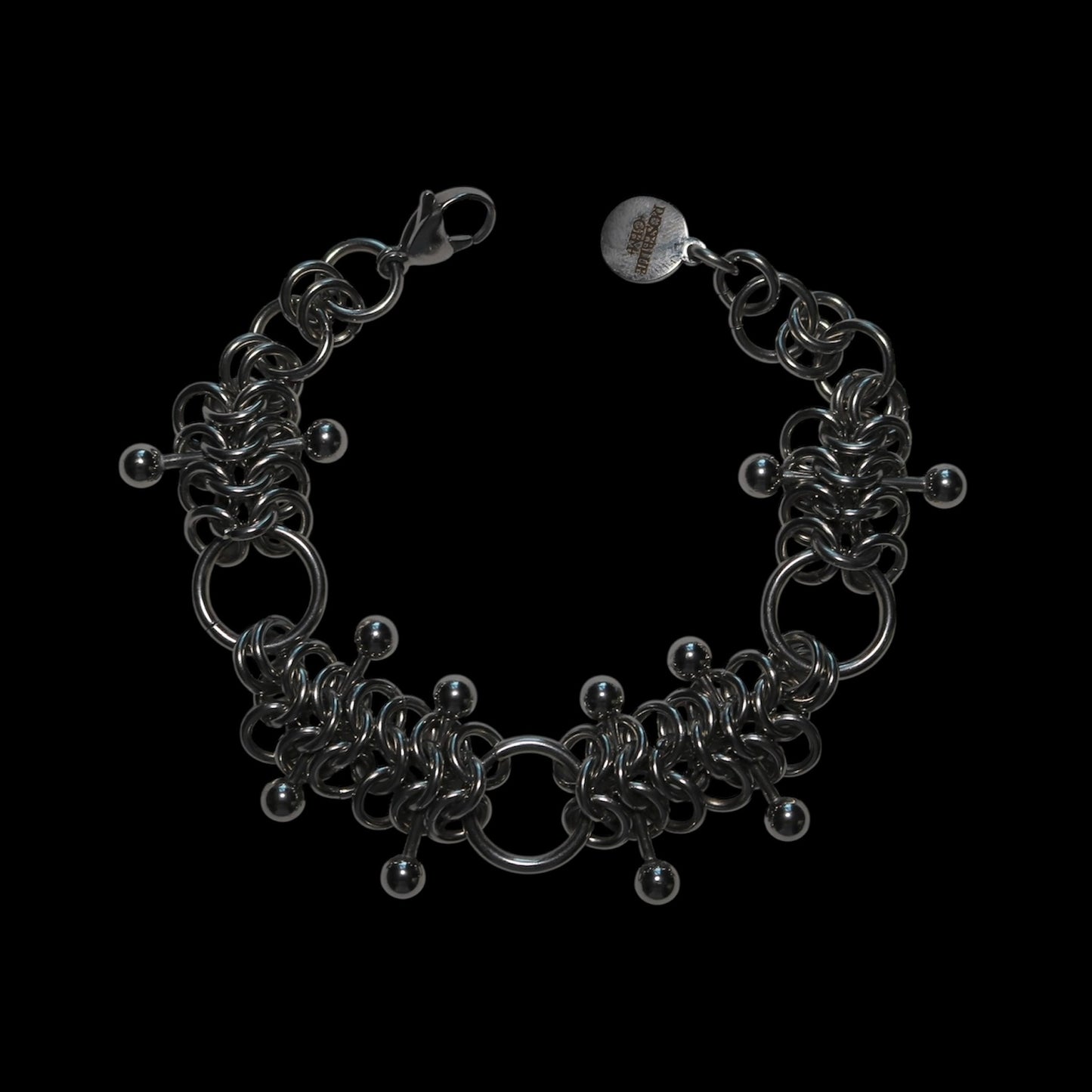 chainmail 4 in 1 bracelet with barbells on a black background