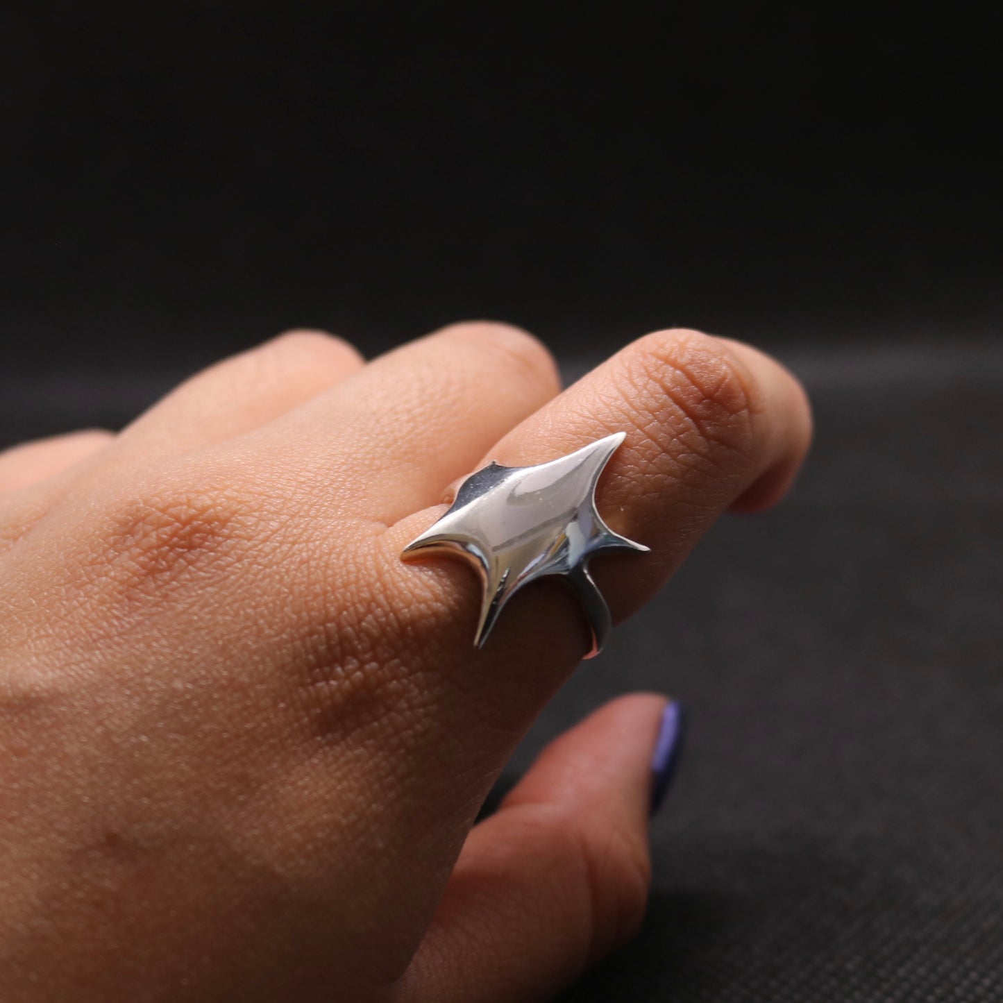 ROSEBLUEGEM- STARBURST RING ON FINGER