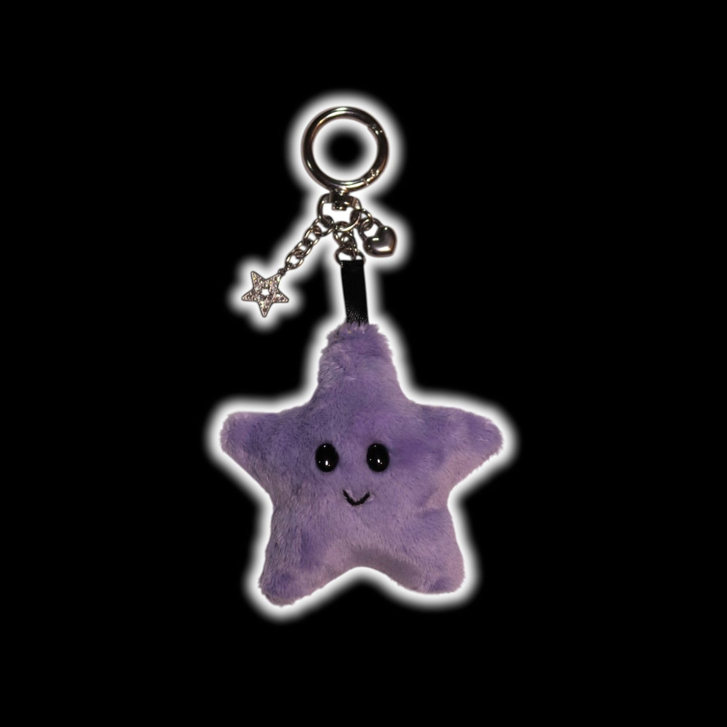 Purple star-shaped keychain with a smiling face on a black background