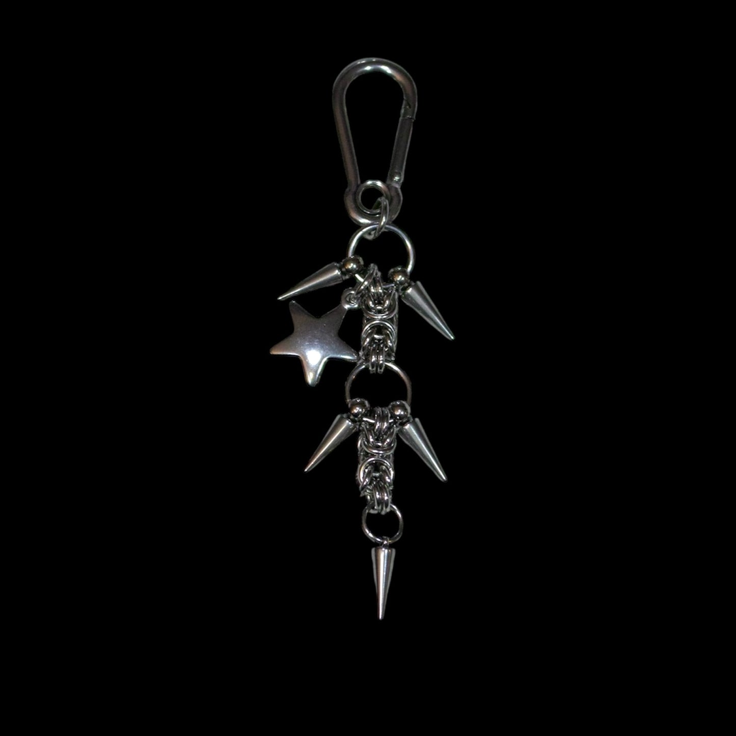 stainless steel keychain with spikes and a star charm on a black background