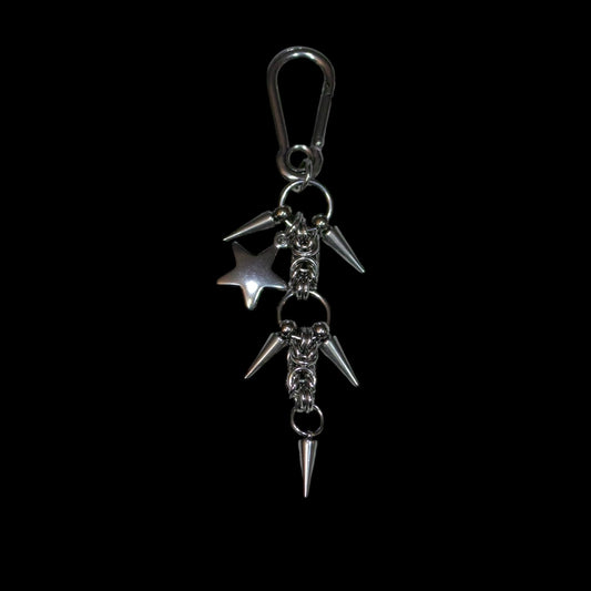stainless steel keychain with spikes and a star charm on a black background