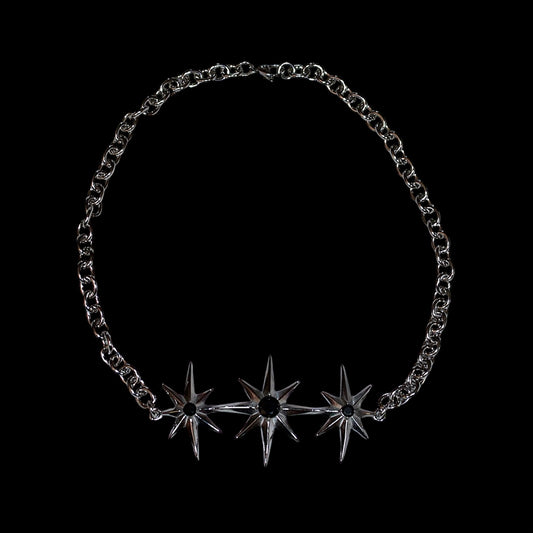 stainless steel chain necklace with north star-shaped pendant on a black background