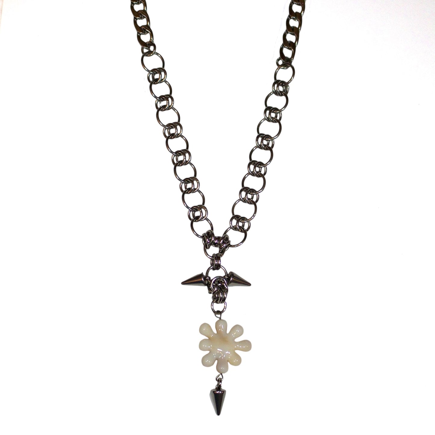 Necklace with a irregular flower like pendant and spike on a white background