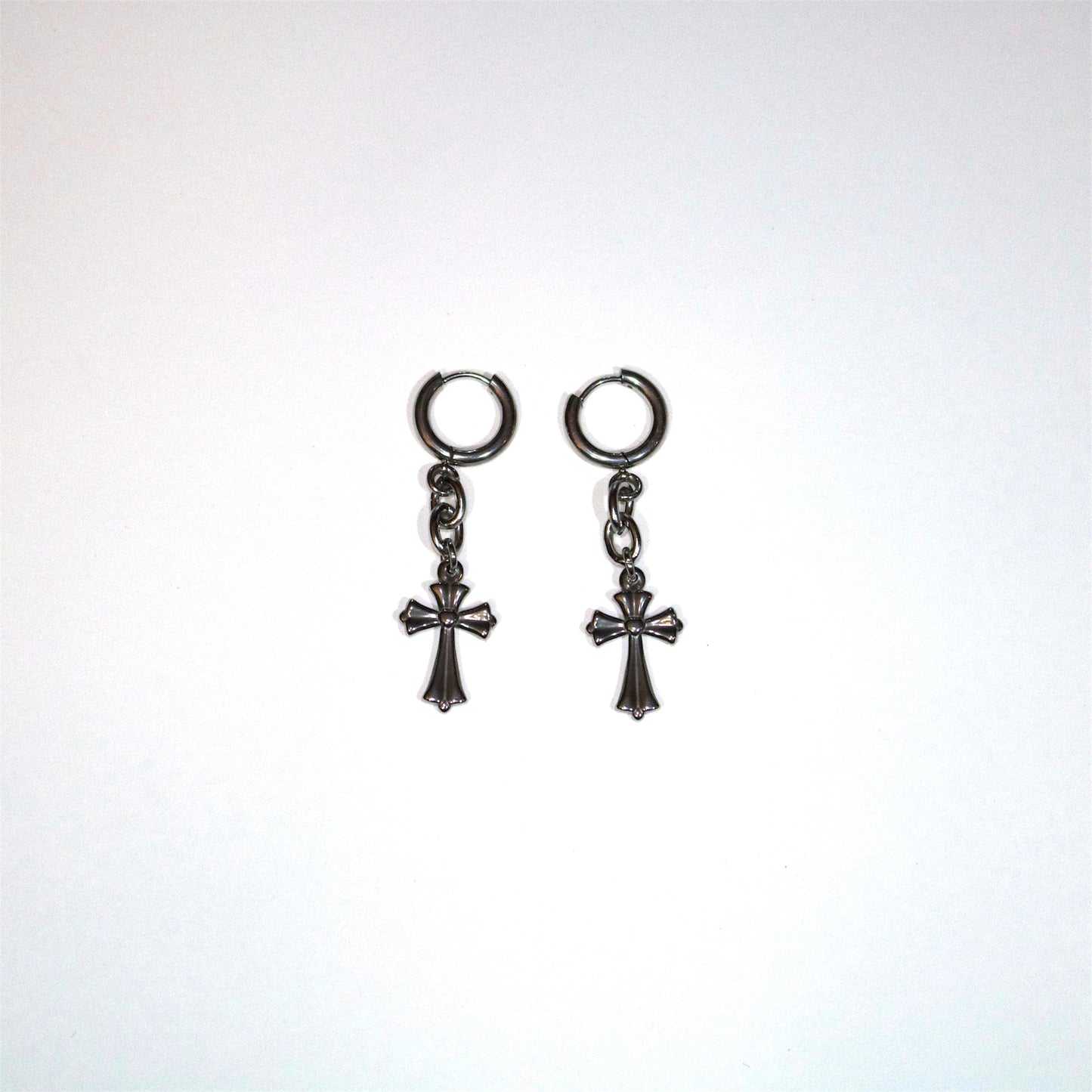 Pair of stainless steel cross drop earrings on a white background