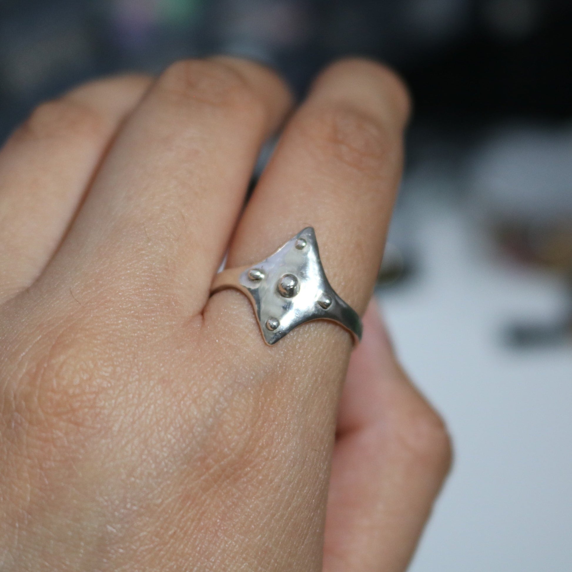 ROSEBLUEGEM- SHIELD RING ON FINGER