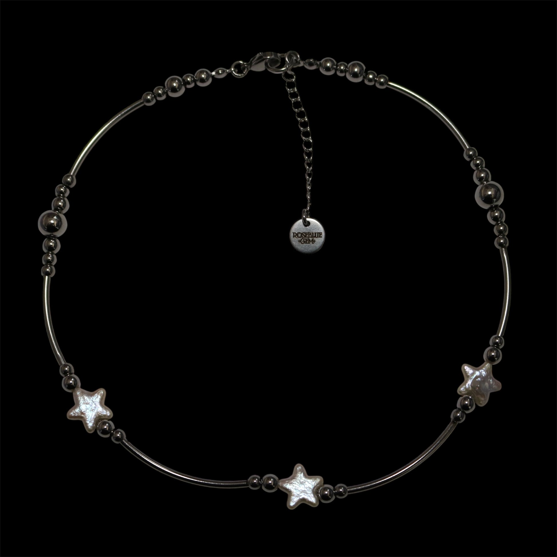 Stainless steel tube necklace with pearl stars on a black background