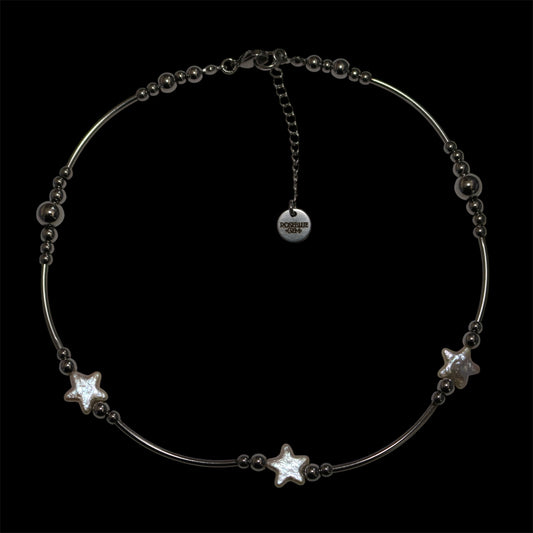 Stainless steel tube necklace with pearl stars on a black background