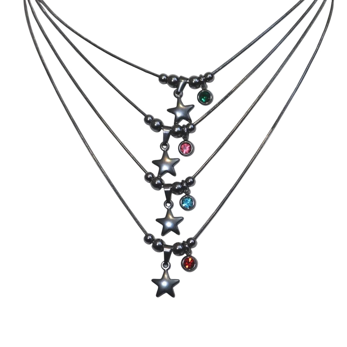 Multiple star necklaces with gemstone pendants on a light gray background