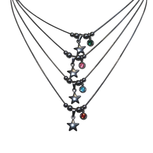 Multiple star necklaces with gemstone pendants on a light gray background