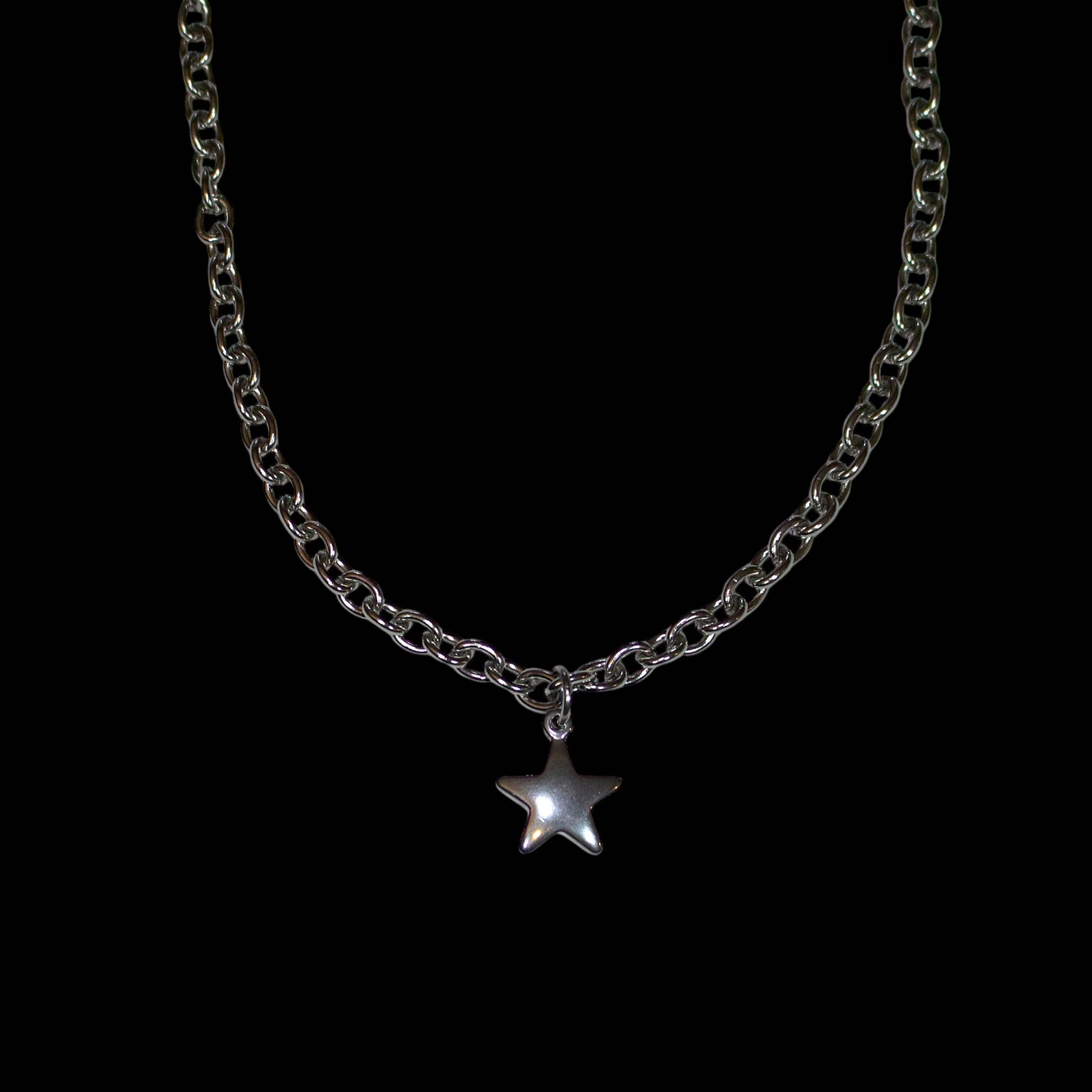 stainless steel chain necklace with a star pendant on a black background